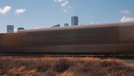 time lapse of cargo train passing by downtown houston, texas