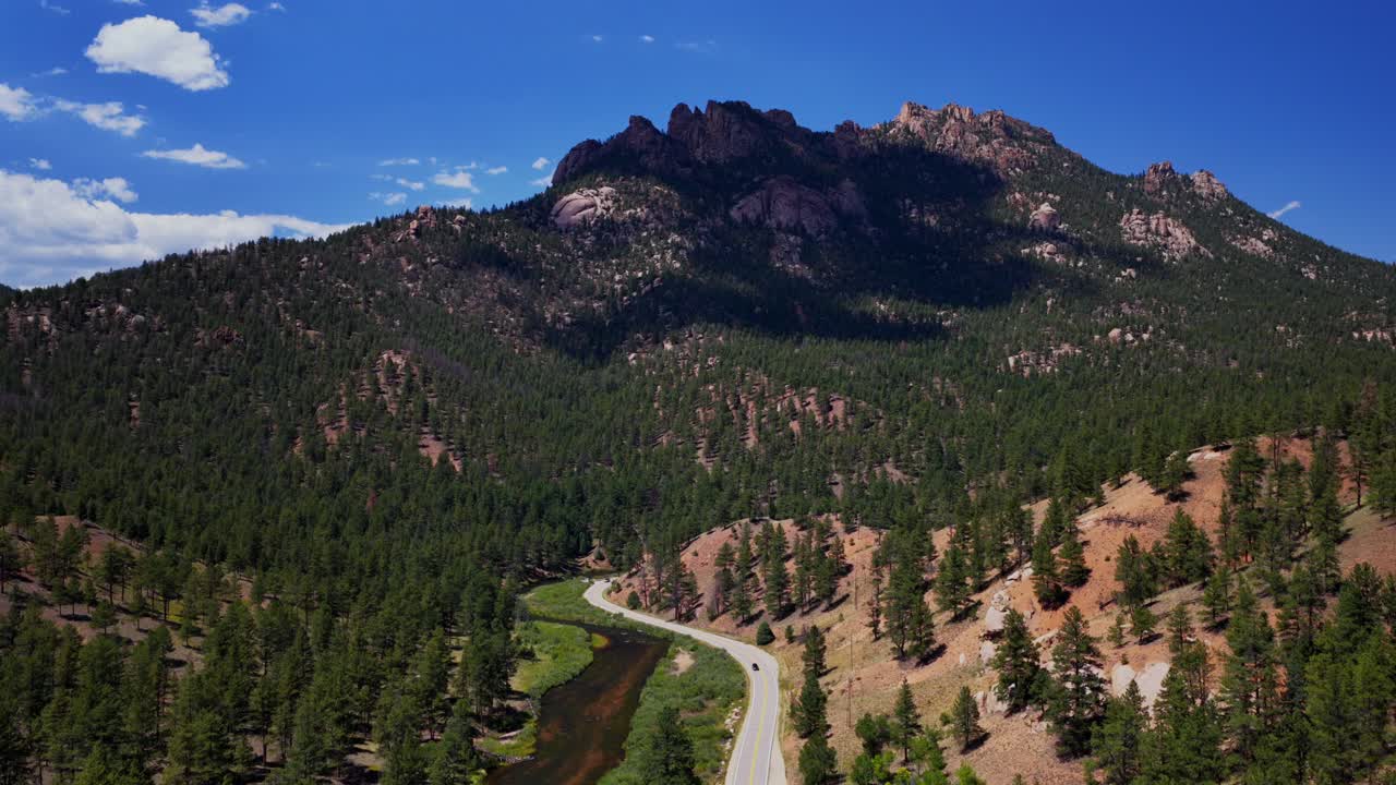 South Platte River Deckers Foxton Conifer Pine aerial drone Colorado Trail summer morning sunny blue sky cloud North Fork Buffalo Creek Platte Canyon Pike National Forest windy road car backwards pan