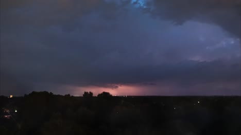 Time-lapse-sequence-of-thunderstorm-lightning-at-night-over-a-village