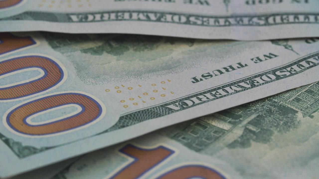 Close-up Macro Shot of Rotating US Hundred Dollar Bills