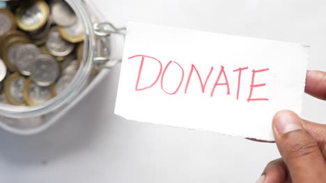 donation jar with 'donate' note