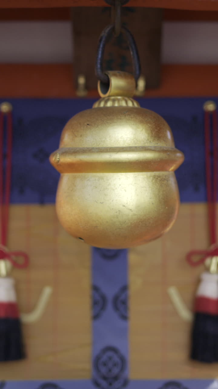 Explore the serene atmosphere of Fushimi Inari with stunning golden bells and traditional architecture