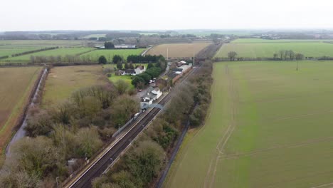 drone footage of a small village train station in kent countryside in england