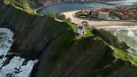 spectacular views of the hermitage of la guia dominating the entrance to the cove of the mythical port of ribadesella in asturias