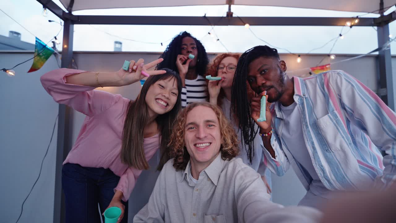 Group selfie at a birthday roof party