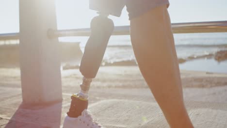 Disabled-woman-using-mobile-phone-while-walking-in-the-beach-4k