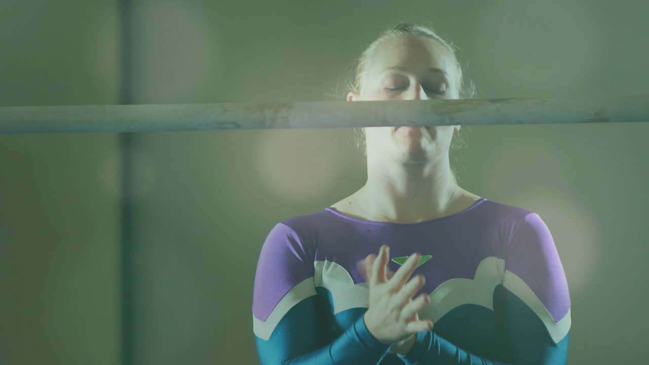 Female gymnast rubbing palms then gripping high bar, animated chalk dust showing grip for training