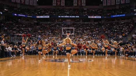 energetic cheerleaders performing at an exciting sports event, captivating the audience with their synchronization and enthusiasm
