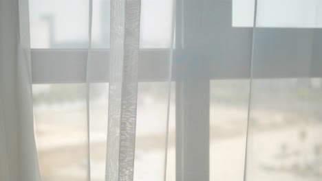 white sheer curtains on a window