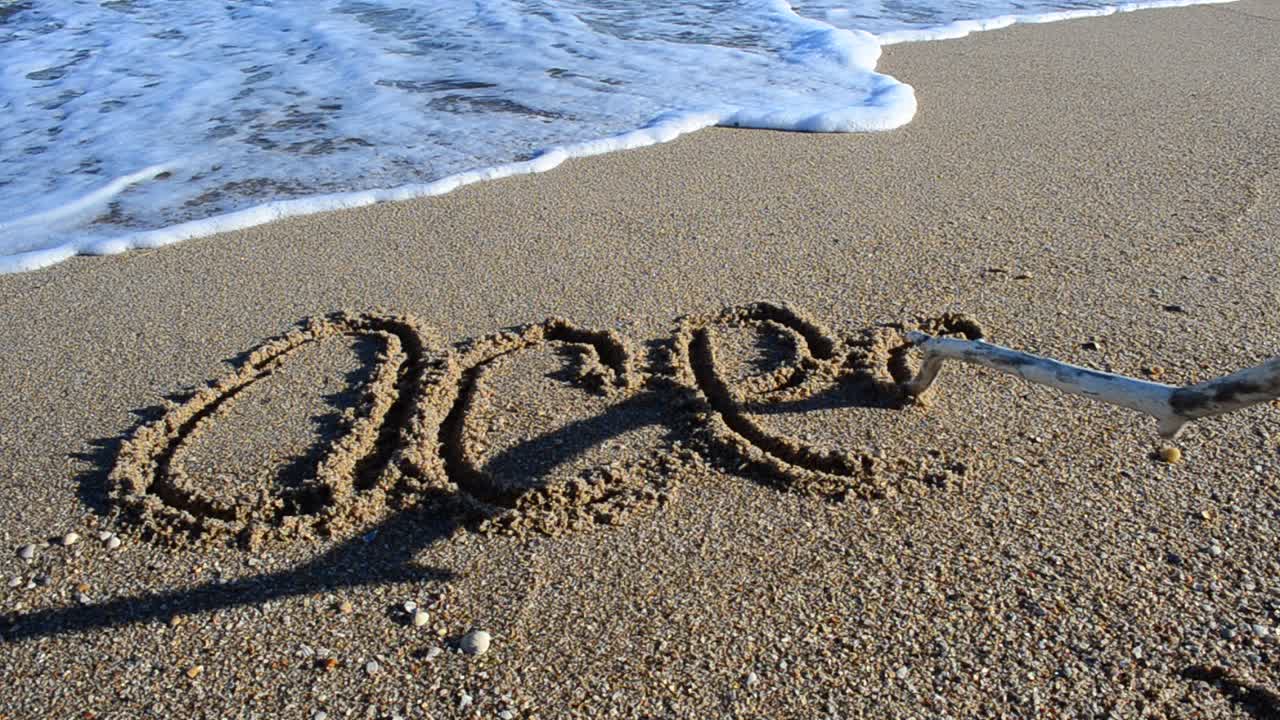 Das Wort 'Ozean' im Sand. Strand. Aufnahme am Strand