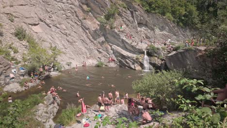 waterfall swimming hole with people swimming