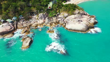 rocky tropical shore with the houses on the waterfront