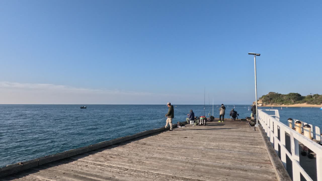 People fishing on a sunny pier