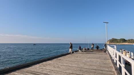 people fishing on a sunny pier