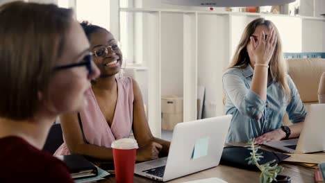 teamwork in stylish loft coworking space. young happy multiethnic creative female employees brainstorm, discuss ideas 4k