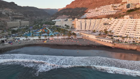 aerial shot approaching the shore of taurito beach on the island of gran canaria, mogan municipality