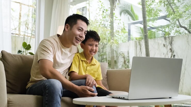 Asian man and boy in the living room