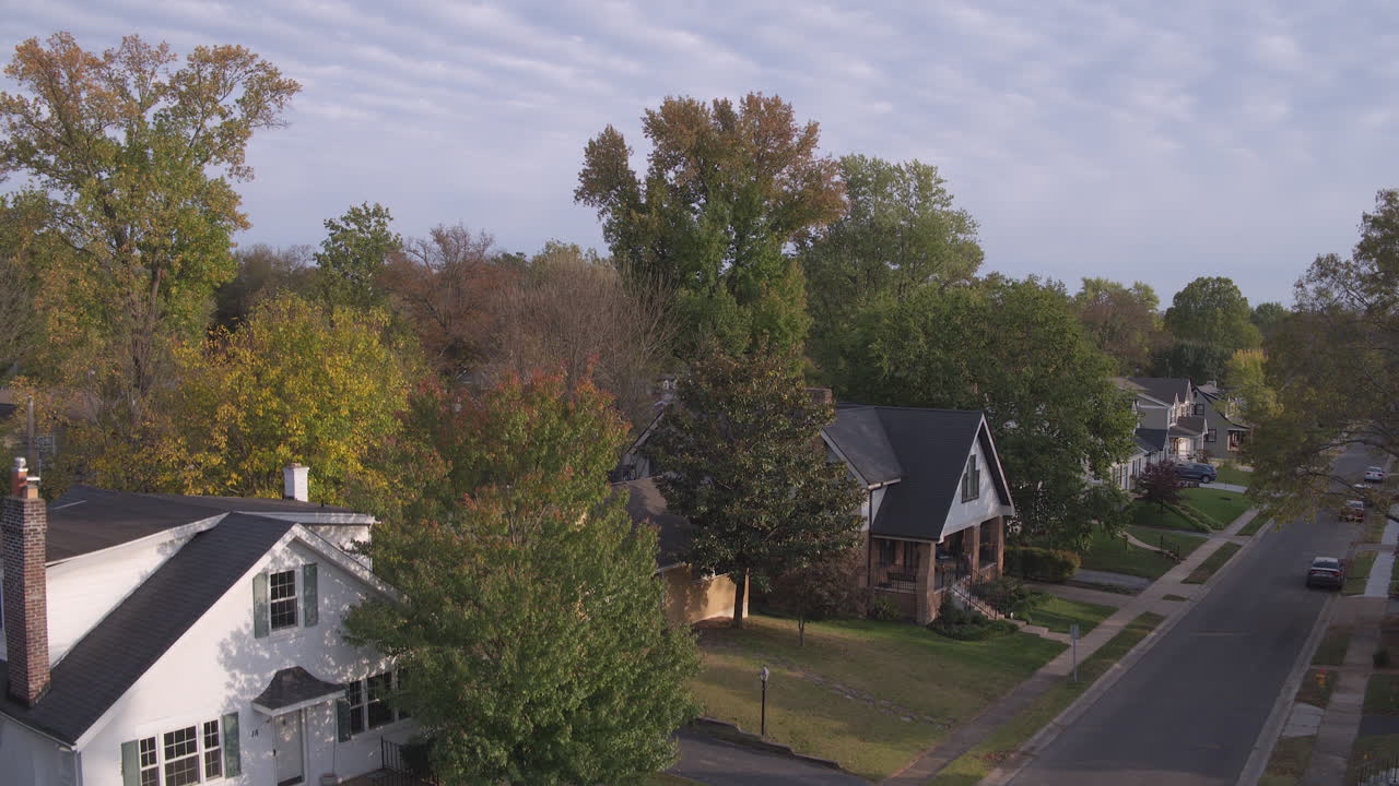 White house and street in suburbs with rise to the horizon and sky
