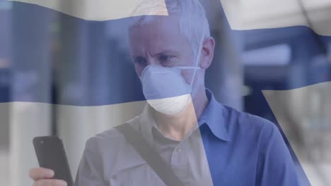 Animación-De-La-Bandera-De-Finlandia-Ondeando-Sobre-Un-Hombre-Con-Mascarillas.