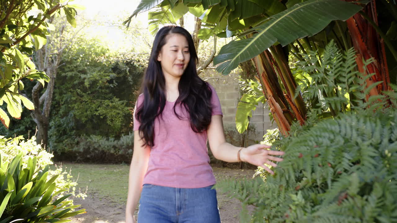 Touching plants and enjoying nature, woman exploring garden outdoors