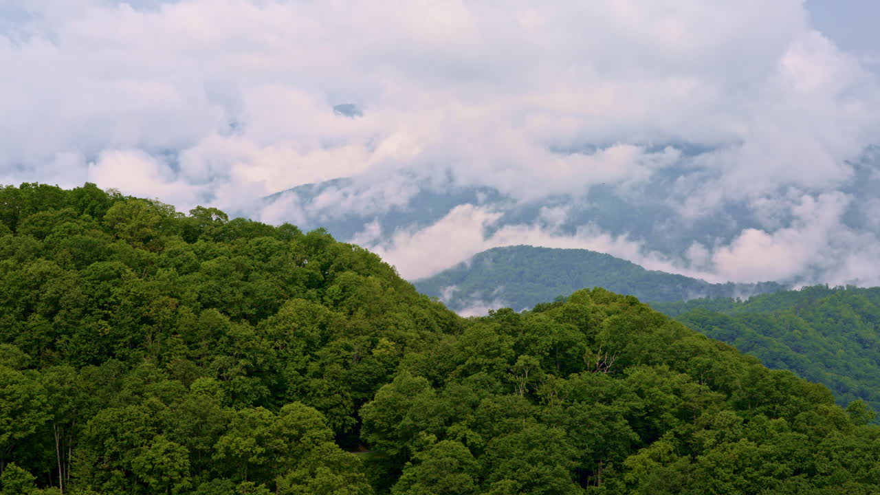 Timeless drone footage of Smoky Mountains fading into clouds and fog