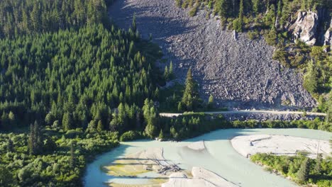 Aerial-Drone-Pushing-Dolly-Shot-of-Soo-River-and-Stones-on-HIllside-4K