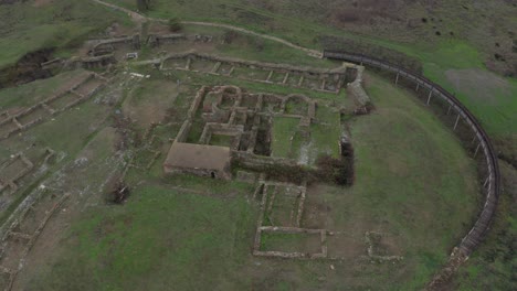 Aerial-view-of-ancient-city-ruins-in-Bulgaria-in-an-empty-green-field