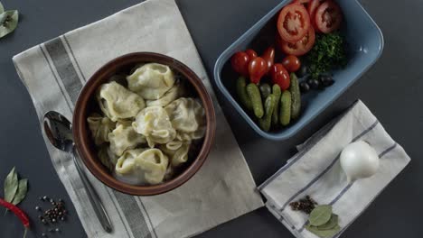 hand picking a dumpling with parsley on top