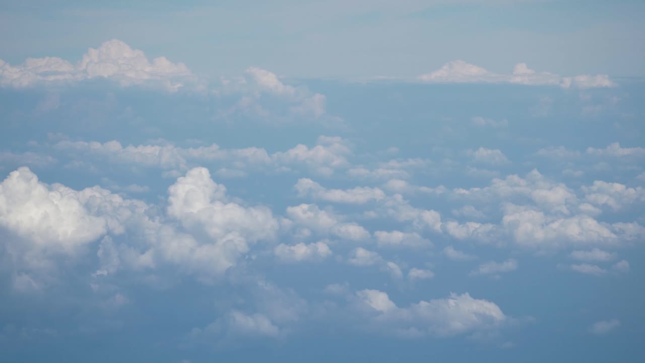 Moving shot of Clouds in the high sky from airoplane window