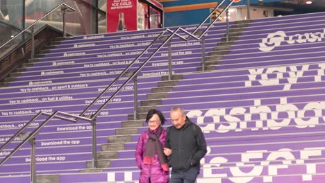 couple descending stairs in southerncross, melbourne