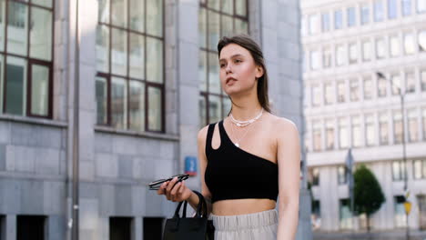 Young-fashionable-woman-walking-down-the-street