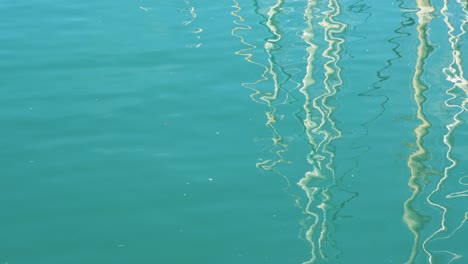 reflections of boats in sea water