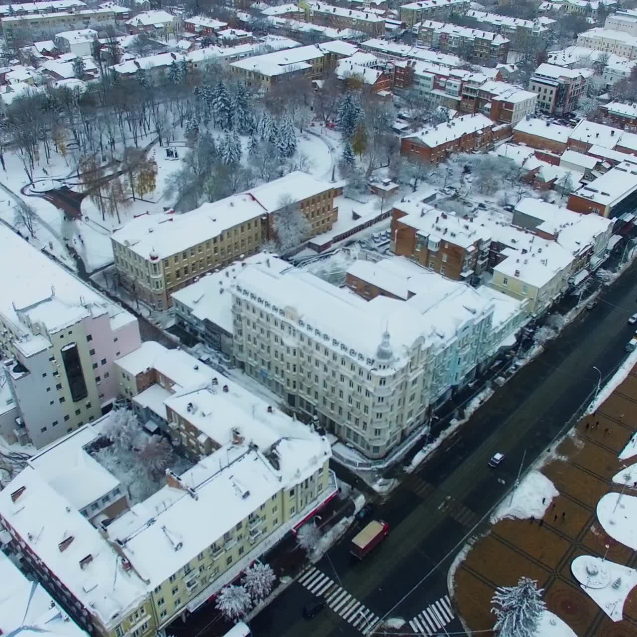 Snowy roofs of the buildings in the city downtown. Beautiful view of the urban landscape on winter day. Top view