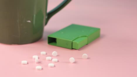 white sugar tablets on a pink background