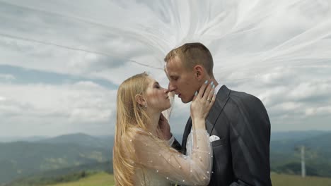 Groom-with-bride-having-fun-on-a-mountain-hills.-Wedding-couple.-Happy-family