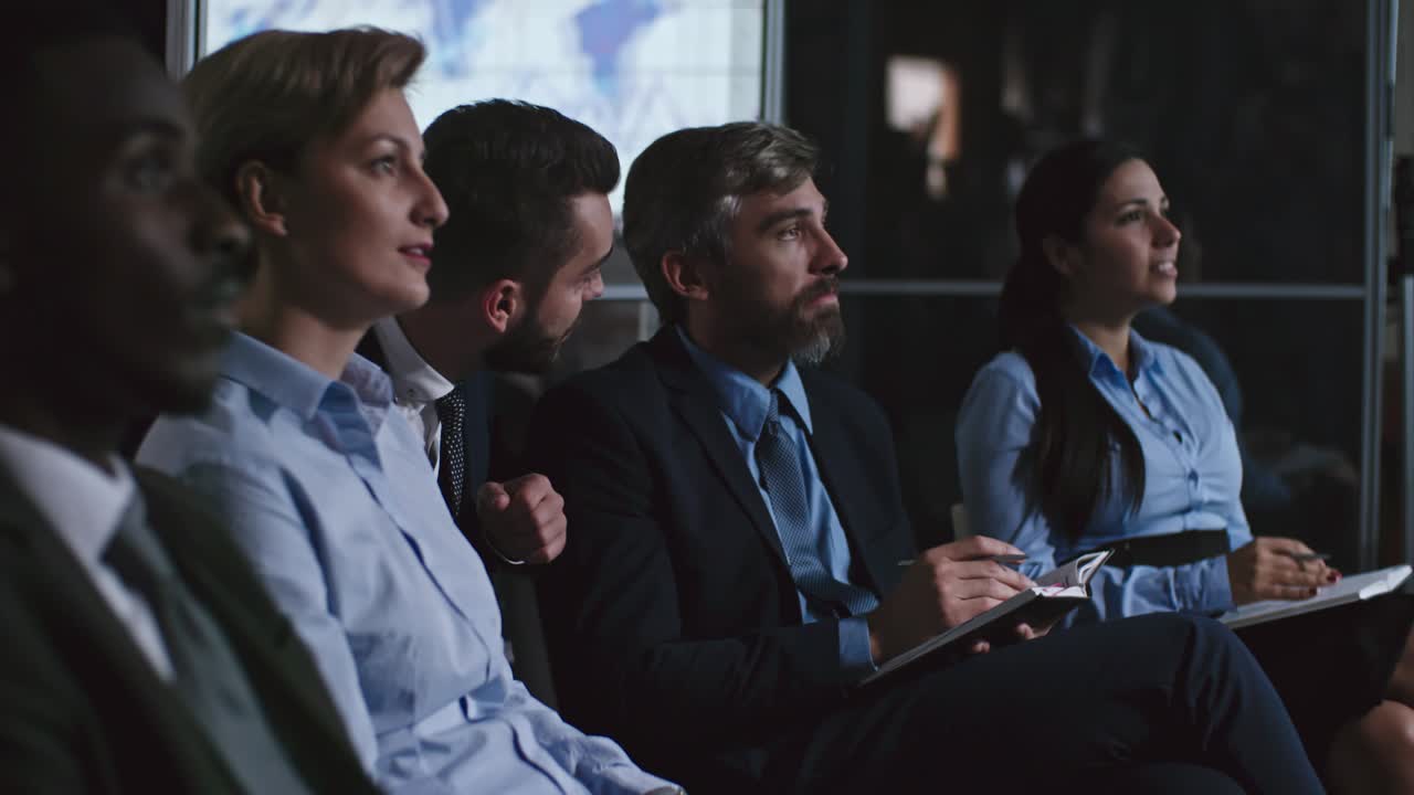 동료들이 프레젠테이션을 보고 질문을 하고 있습니다.