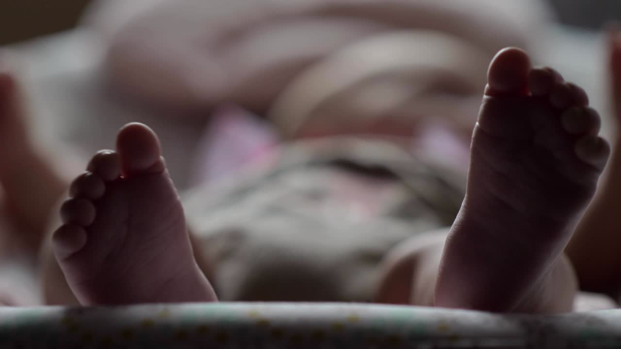 Baby in rocking chair, view to little feet