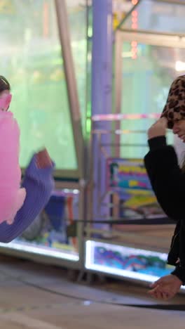 friends enjoying cotton candy at a fair