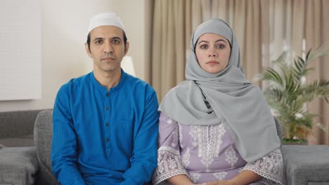 serious muslim couple staring at the camera