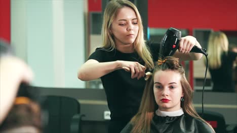 hairstylist styling hair in a salon