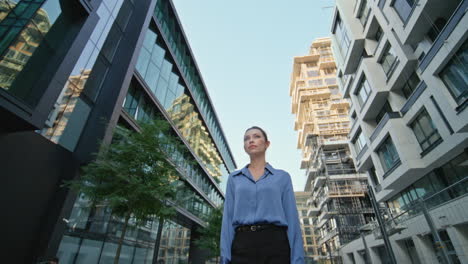 successful woman ceo posing in urban area crossing hands. businesswoman posing