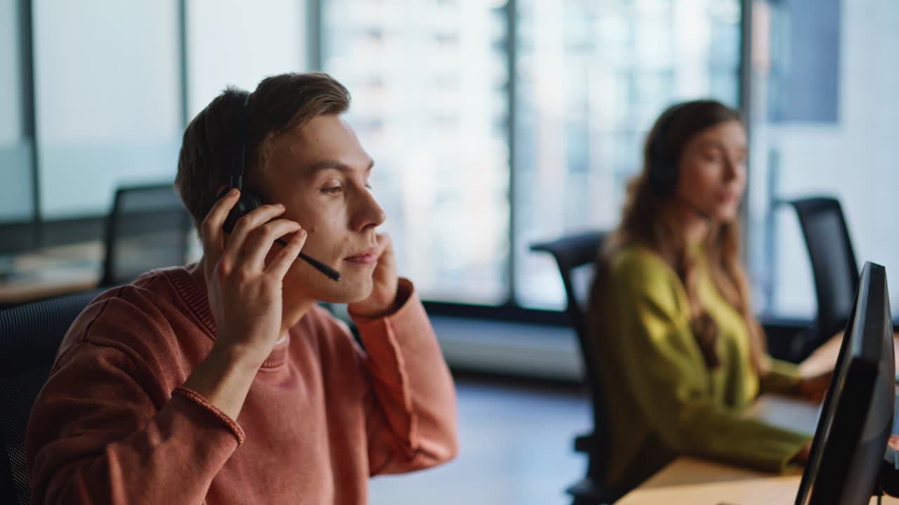 Man operator taking headset from computer closeup. Businessman work call center