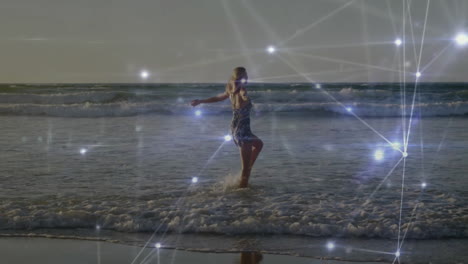 Walking on beach, woman surrounded by animation of glowing network connections