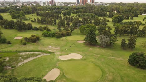 golfer and caddie in buenos aires golf club