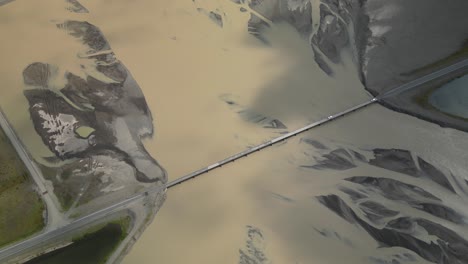 car crossing glacier river over a long bridge in south iceland