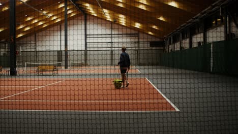 indoor tennis court with player