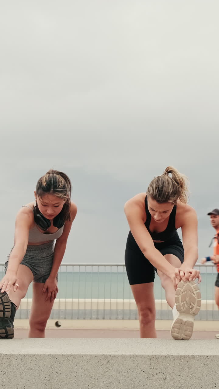 Friends Stretching Together By The Beach