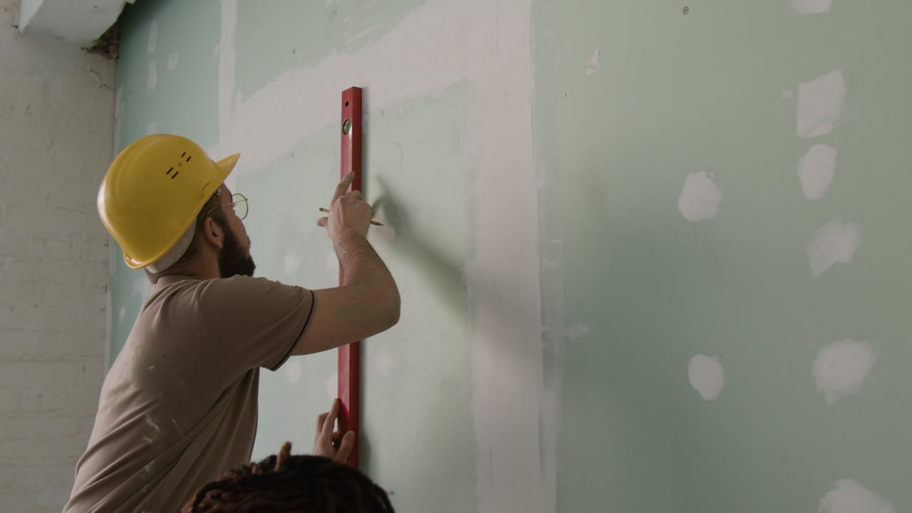 Construction Team Working on Drywall