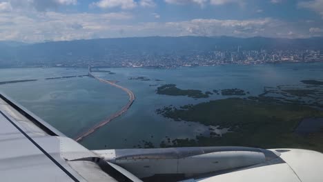 Airplane-Flying-Above-Sea-Before-Landing,-Bridge-and-Landscape-Before-Landing-on-Cebu-City-Airport,-Philippines