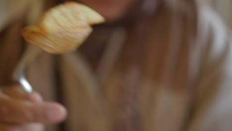 woman eating potato wedges